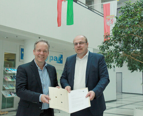 Daniel Lüngen überreicht Klaus Grootens die offizielle Haushaltsverfügung. (Foto: OBK)