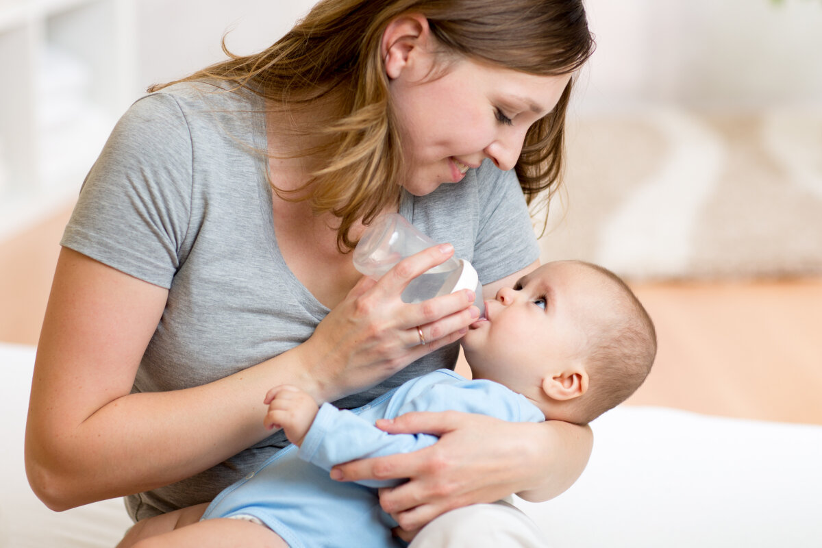 young mother feeding her adorable baby