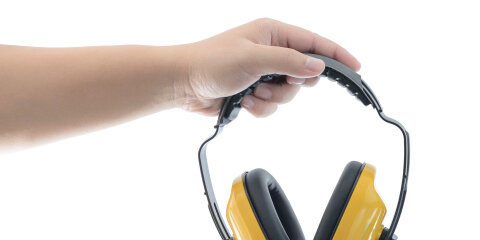 Hands holds working protective headphones is Isolated