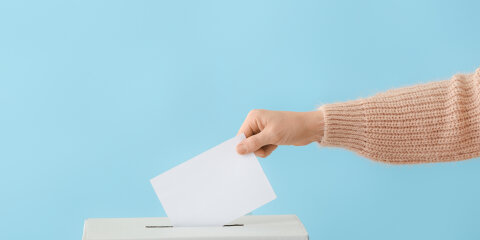 Voting woman near ballot box on color background